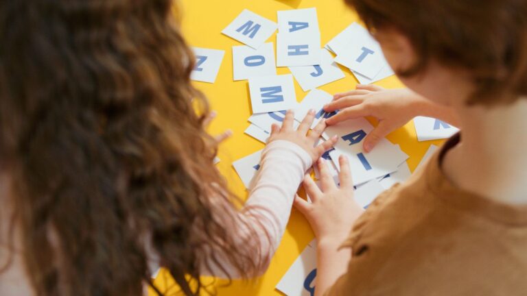 Children playing KS2 spelling games with alphabet cards at home